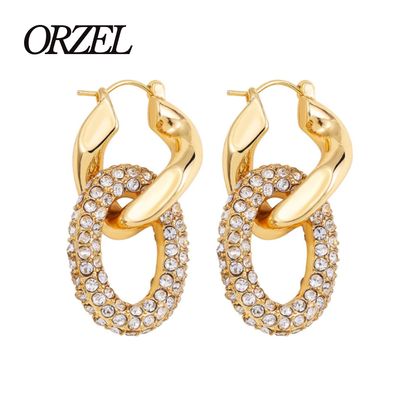 Boucles d’oreilles torsadées – style punk chic avec zircons brillants.