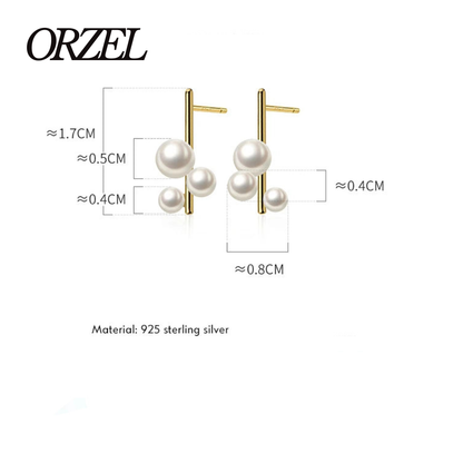 Boucles d’oreilles clous géométriques en argent 925 avec perle élégante.