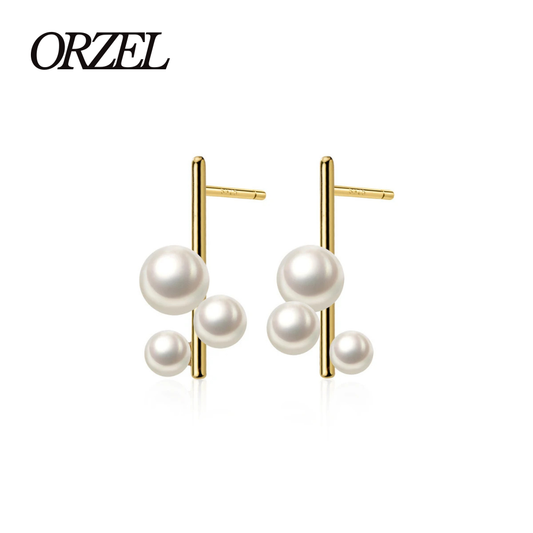 Boucles d’oreilles clous géométriques en argent 925 avec perle élégante.