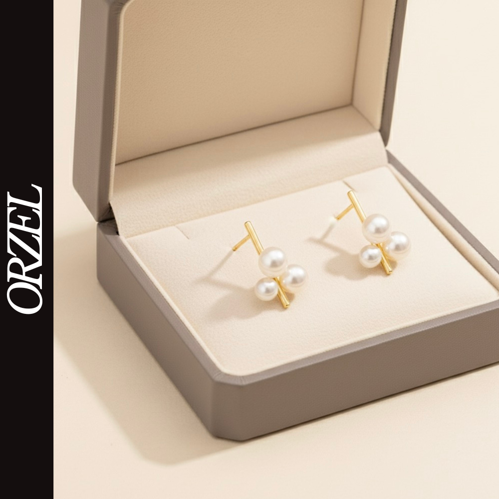 Boucles d’oreilles clous géométriques en argent 925 avec perle élégante.