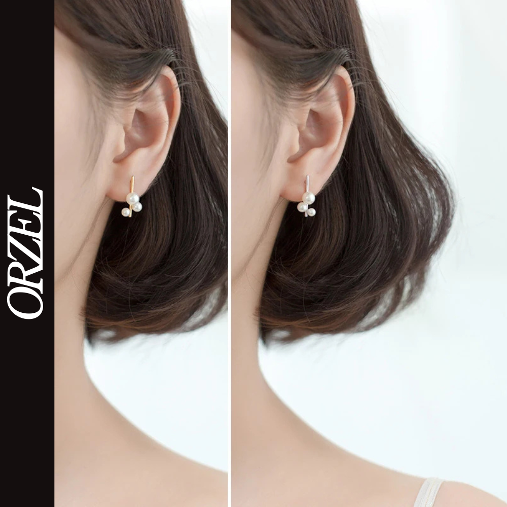 Boucles d’oreilles clous géométriques en argent 925 avec perle élégante.