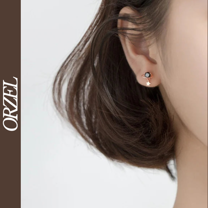 Boucles d’oreilles planète noire en argent 925 avec cristal scintillant.