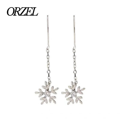 Boucles d’oreilles femme en argent 925 – Flocon de neige avec pompon long.